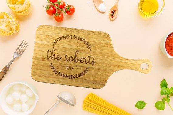 Custom bamboo cutting board with laser-etched design, showcasing dual-purpose functionality for food preparation and display.