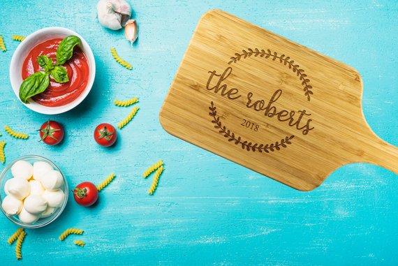 Custom bamboo cutting board with laser-etched design, showcasing dual-purpose functionality for food preparation and display.