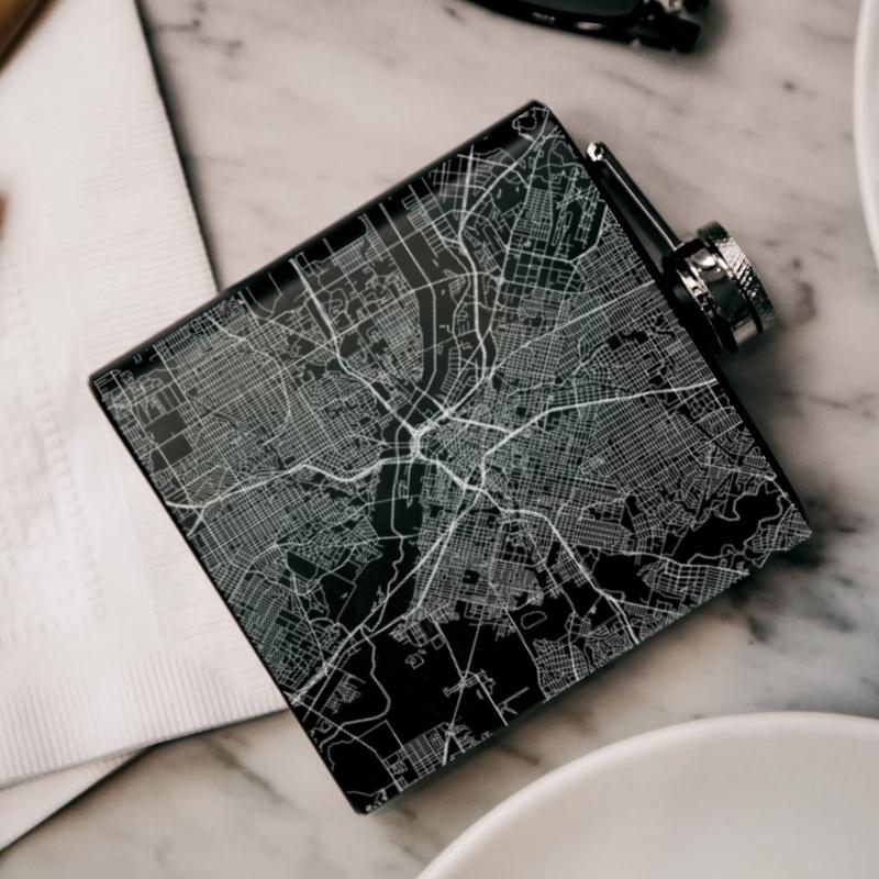 Custom engraved matte black hip flask featuring a detailed map of Dallas, Texas with coordinates.