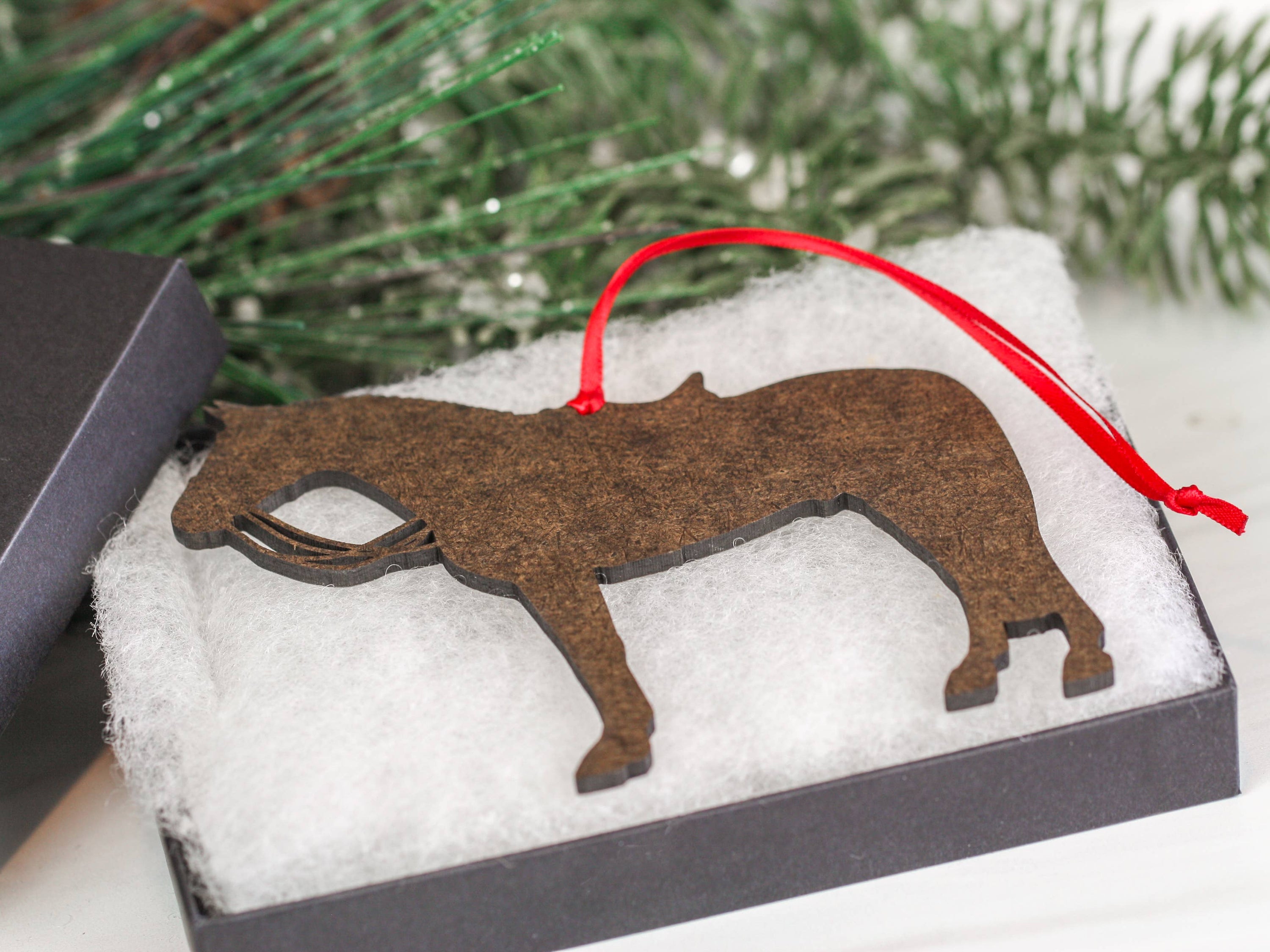Dapple gray dressage horse Christmas ornament with red and black ribbons, handcrafted from composite wood.