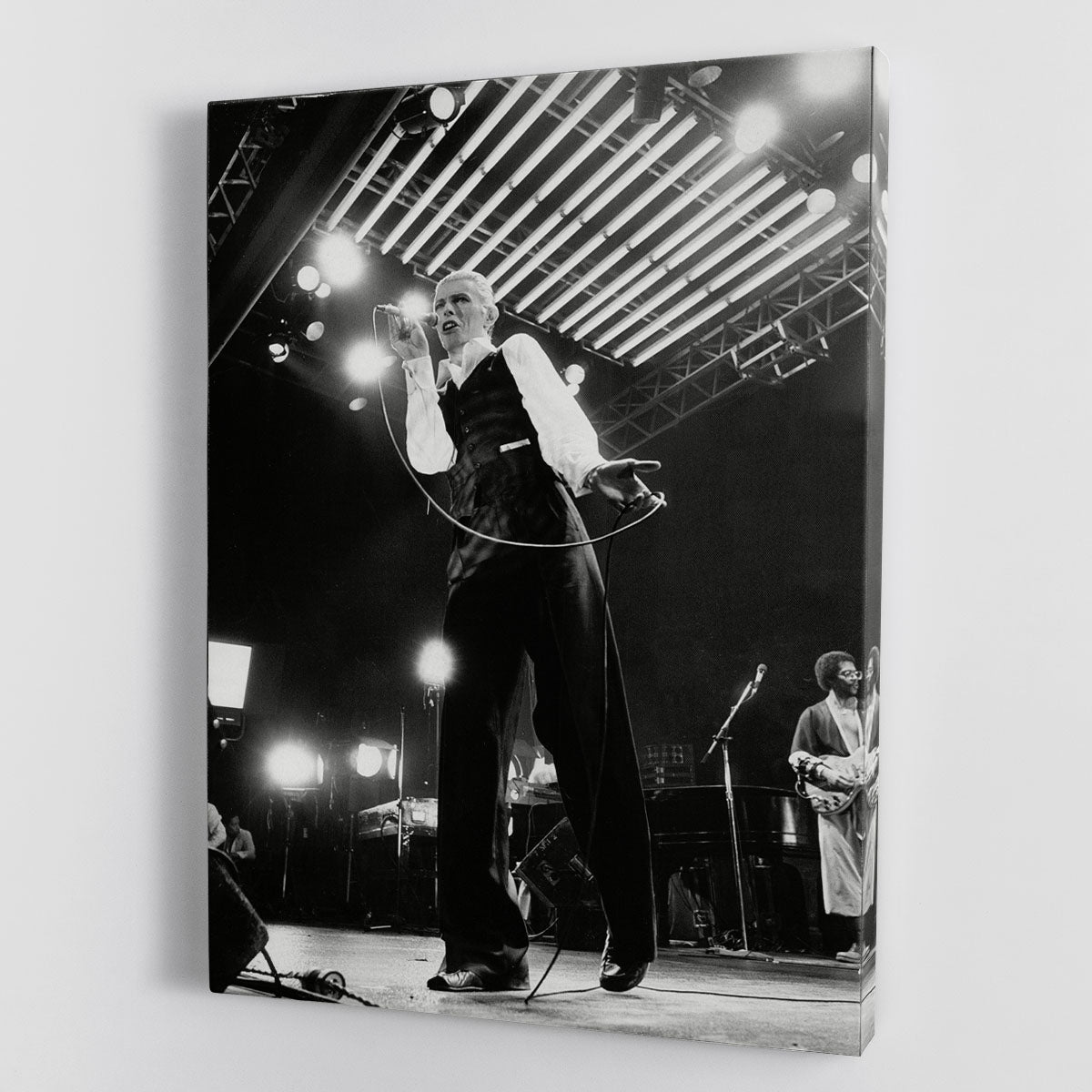 David Bowie performing at Wembley, captured in a vibrant canvas print or poster, showcasing his iconic style and energy.