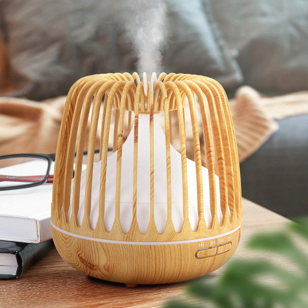 Devanti 4-In-1 Aroma Diffuser in light wood grain design, showcasing its sleek caged structure and LED night light features.