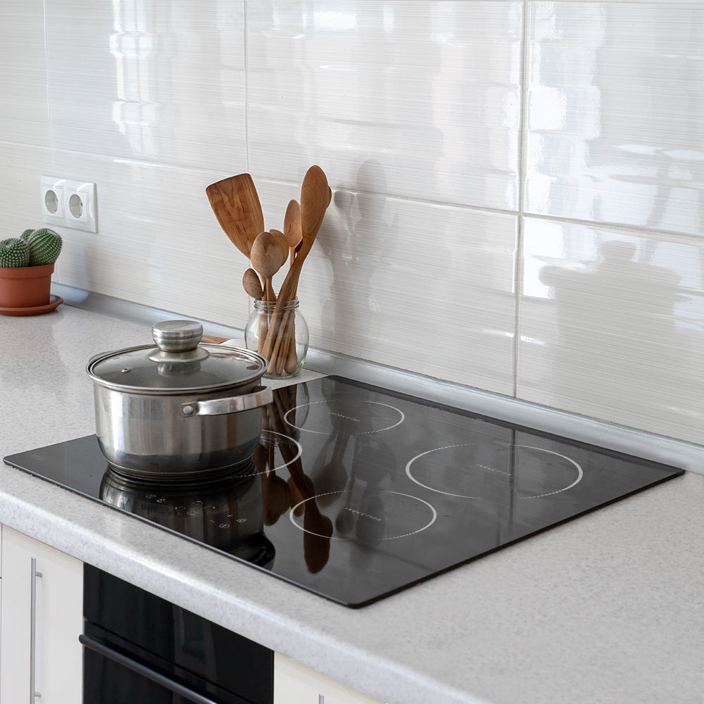 Devanti Induction Cooktop 60cm with 4 burners, featuring a sleek black ceramic glass surface and touch control panel.
