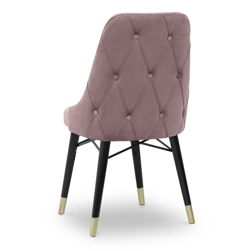 Set of four EDMOND velvet dining chairs in rotten apple color with black legs and gold accents, showcasing their luxurious design.