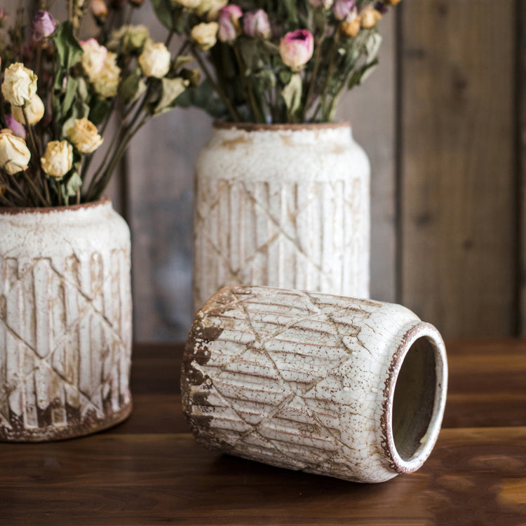 Distressed white ceramic flower jar vase with textured finish, showcasing unique handmade details.