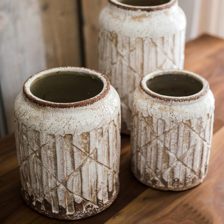 Distressed white ceramic flower jar vase with textured finish, showcasing unique handmade details.