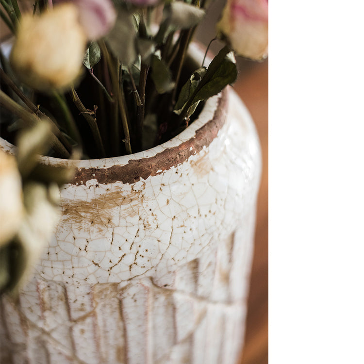 Distressed white ceramic flower jar vase with textured finish, showcasing unique handmade details.