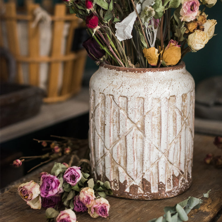 Distressed white ceramic flower jar vase with textured finish, showcasing unique handmade details.