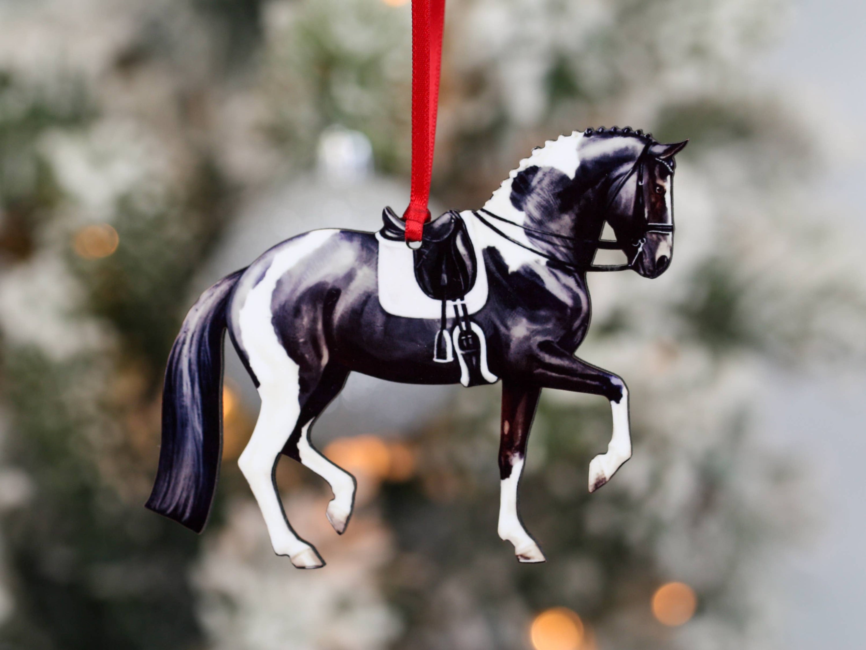 Black and white tobiano sport horse ornament, handmade from composite wood, featuring a glossy front and dark brown back.