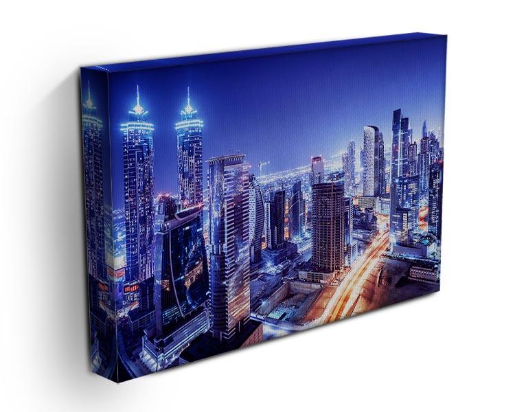 A vibrant canvas print of Dubai's downtown night scene, showcasing illuminated skyscrapers and a stunning skyline.
