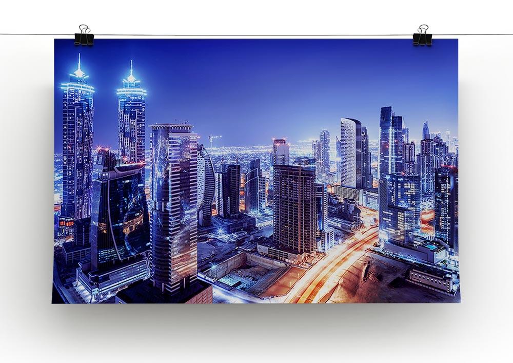 A vibrant canvas print of Dubai's downtown night scene, showcasing illuminated skyscrapers and a stunning skyline.