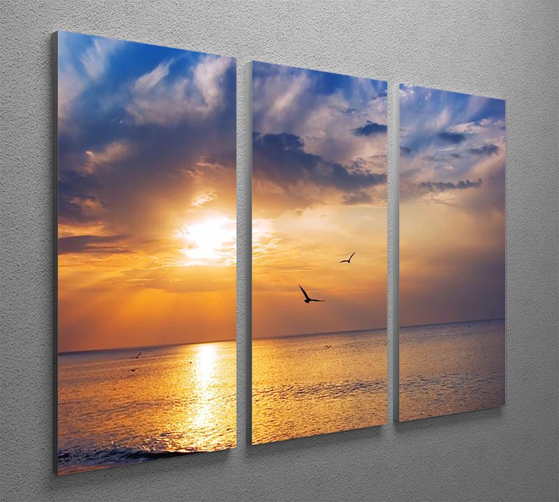 A beautiful 3-panel canvas depicting an early morning sunrise over the sea with birds flying, showcasing vibrant colors and serene scenery.