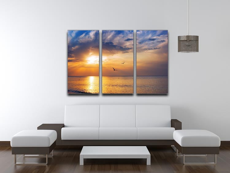 A beautiful 3-panel canvas depicting an early morning sunrise over the sea with birds flying, showcasing vibrant colors and serene scenery.