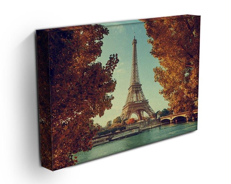 Eiffel Tower surrounded by autumn foliage, showcasing vibrant fall colors in a stunning canvas print.