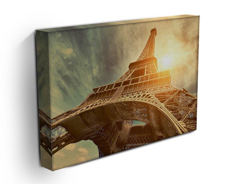 A beautiful canvas print of the Eiffel Tower illuminated by sunlight, showcasing intricate details and vibrant colors.
