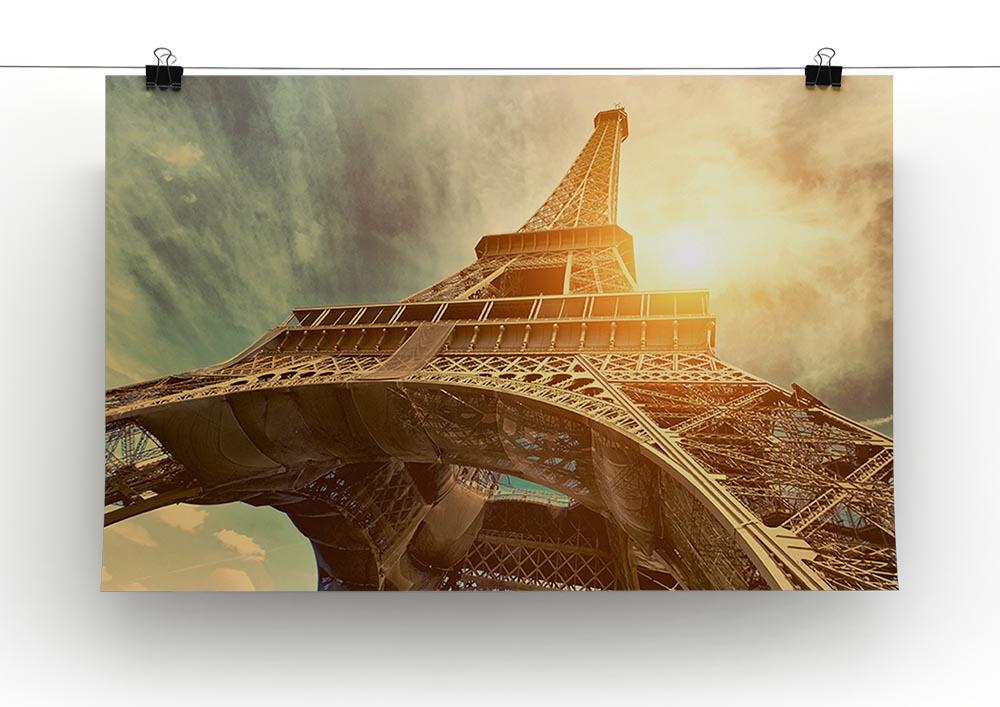 A beautiful canvas print of the Eiffel Tower illuminated by sunlight, showcasing intricate details and vibrant colors.