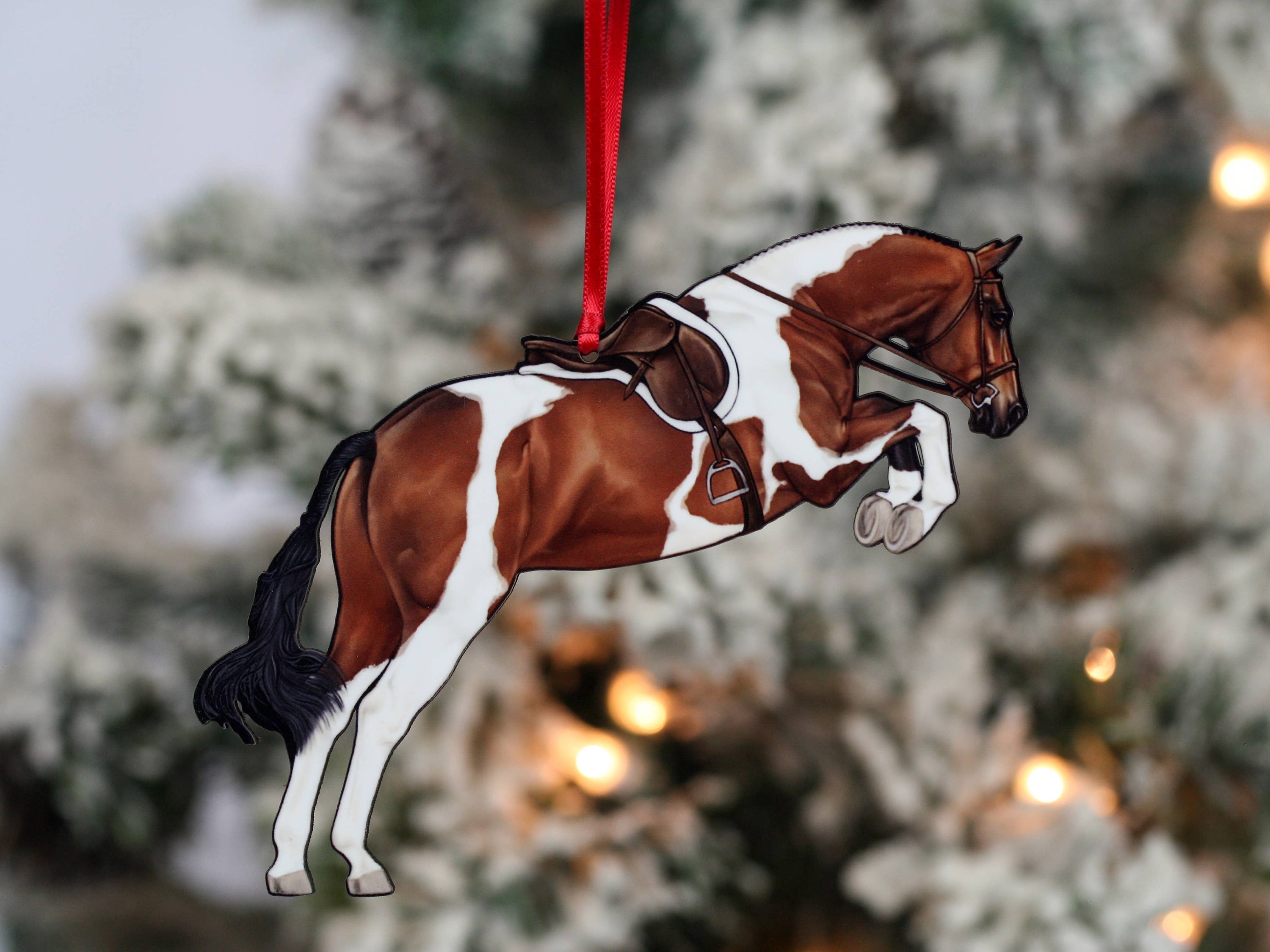 Elegant Equestrian Bay Tobiano Horse Ornament featuring a bay and white design with red and black ribbons, perfect for holiday decor.