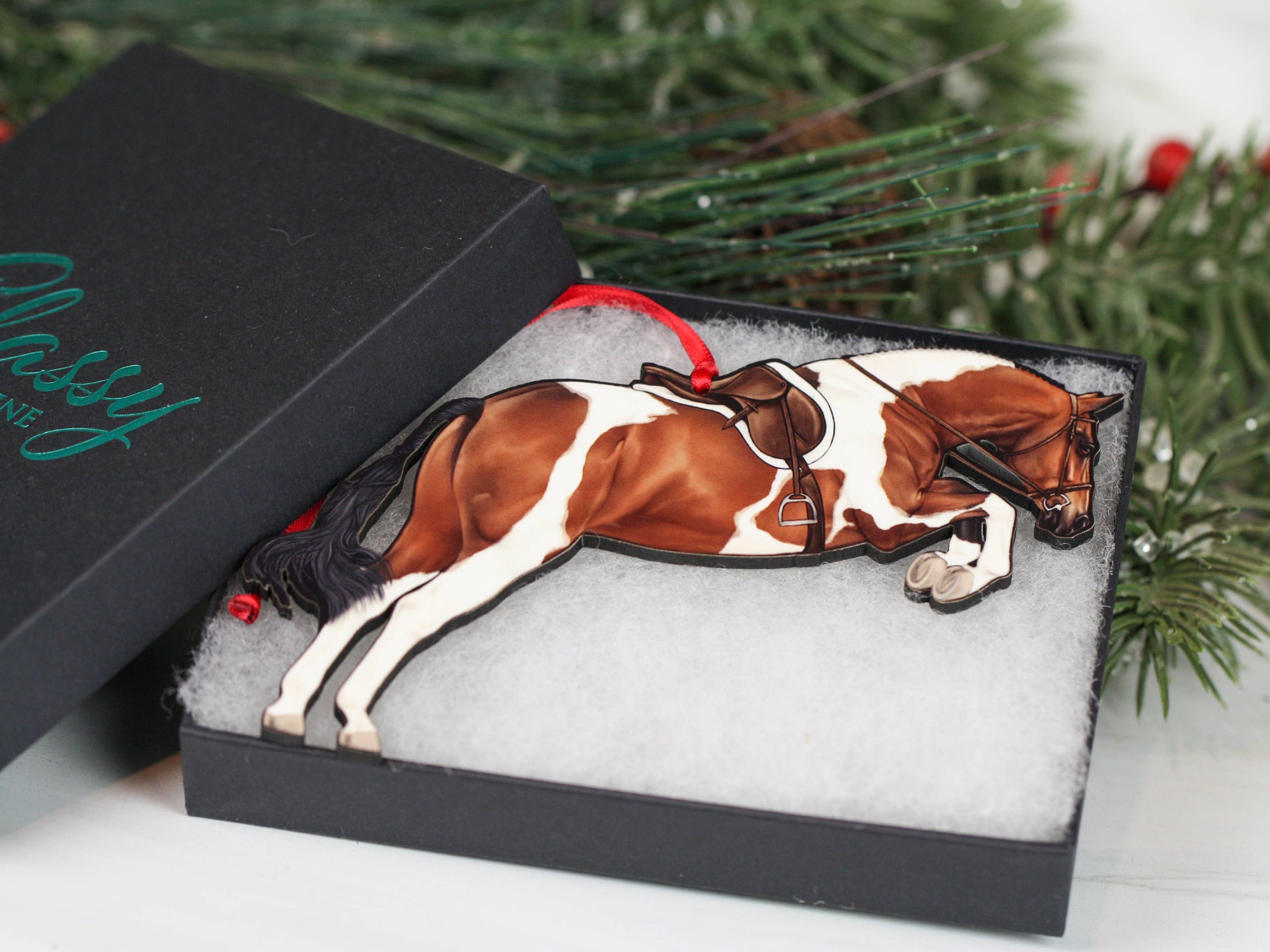 Elegant Equestrian Bay Tobiano Horse Ornament featuring a bay and white design with red and black ribbons, perfect for holiday decor.
