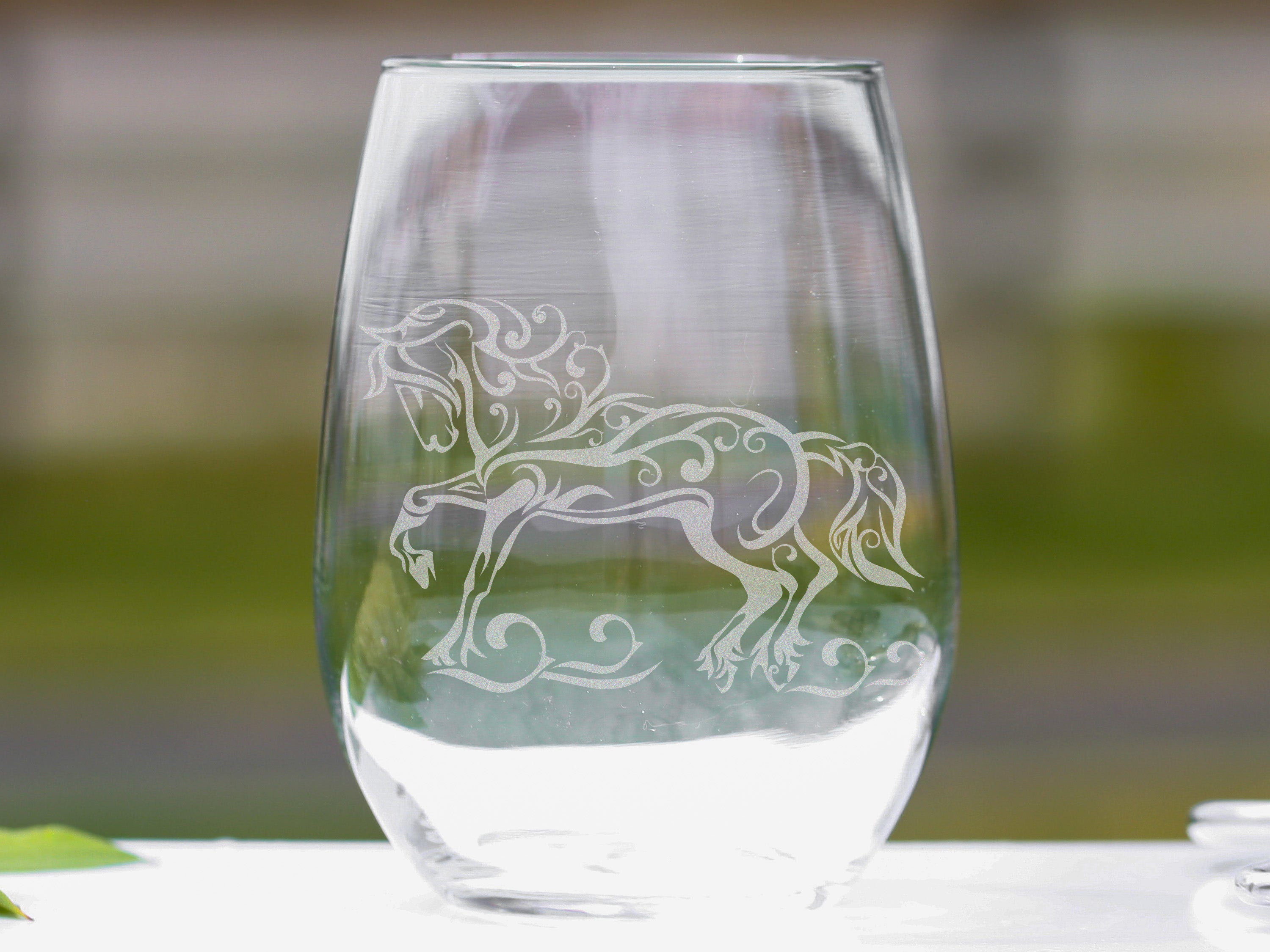 Elegant stemless wine glasses featuring a Friesian Horse design, perfect for wine enthusiasts and equestrian lovers.