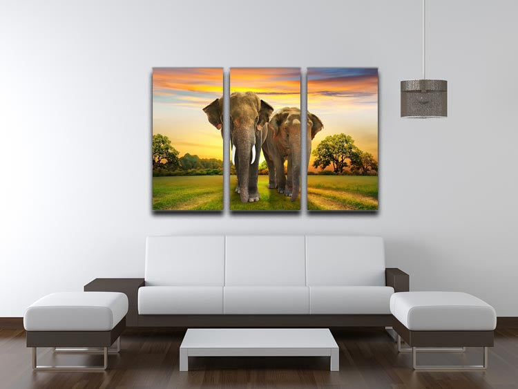 Three-panel canvas print featuring an elephant family against a vibrant sunset, showcasing nature's beauty.