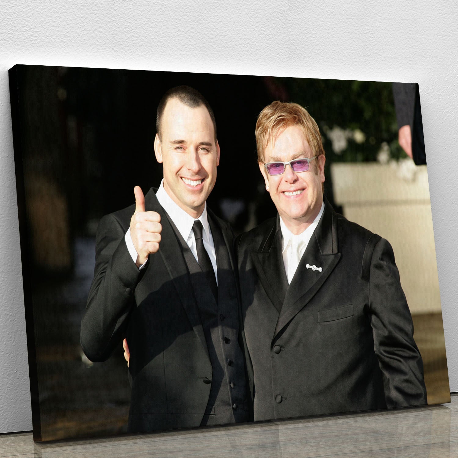 A vibrant canvas print featuring Elton John and David Furnish, showcasing their iconic style and love, perfect for home decor.