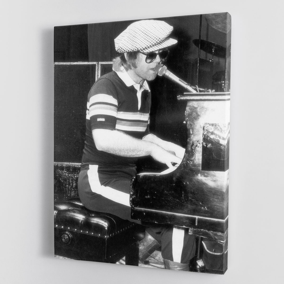 Elton John performing at the piano, captured in a vibrant canvas print or poster, showcasing his musical talent and charisma.