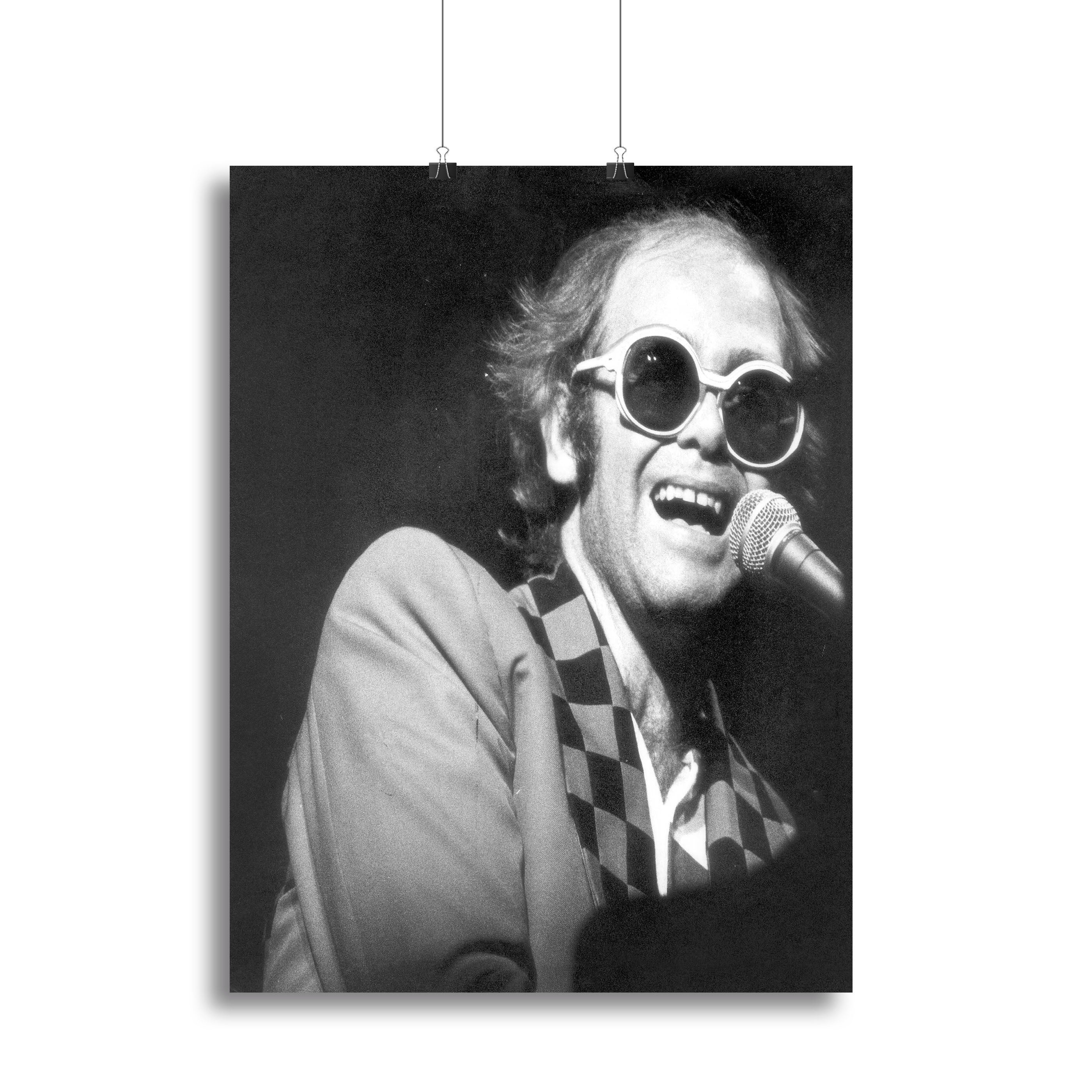 Elton John performing live in concert in 1977, captured in a vibrant canvas print or poster, showcasing his iconic style and stage presence.