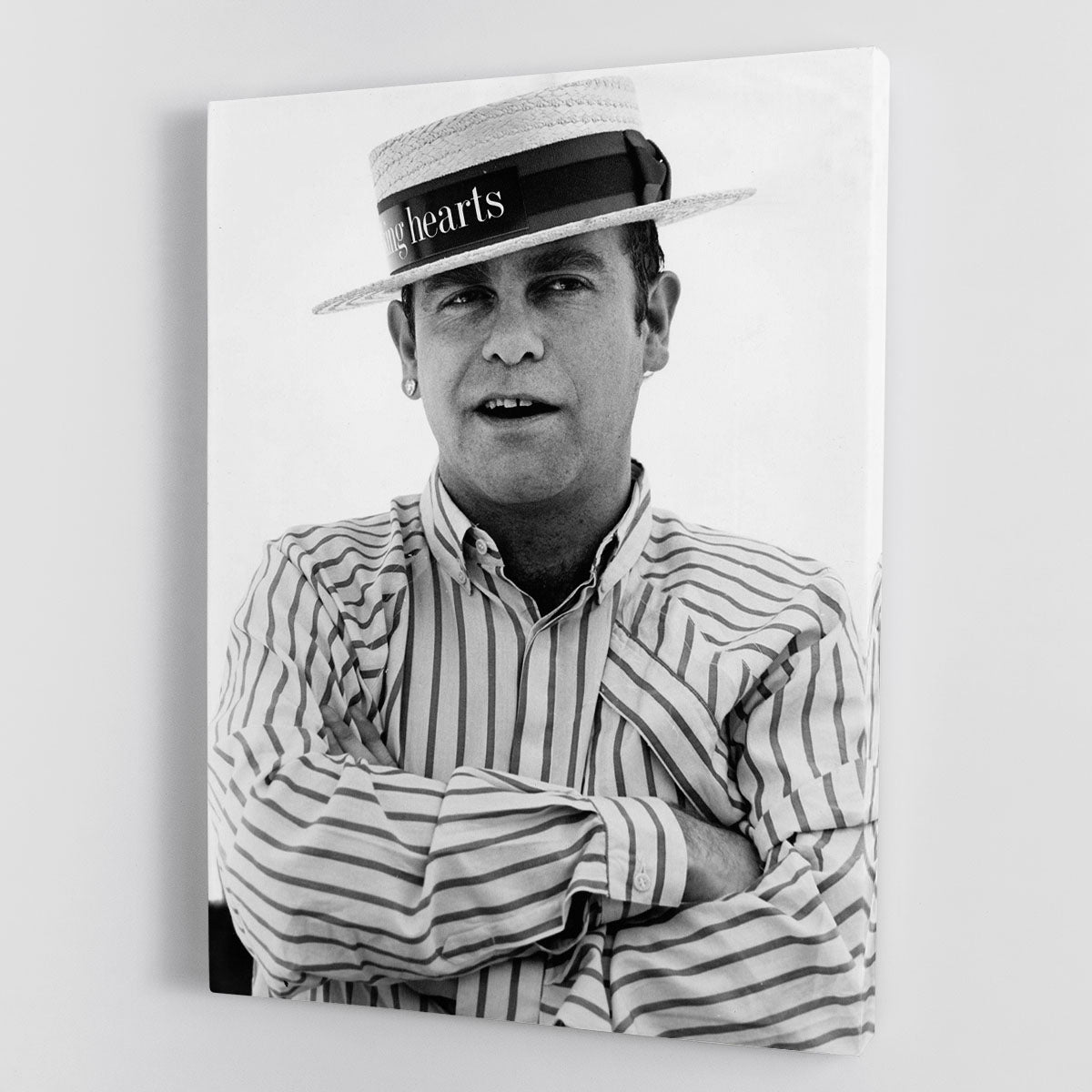 Canvas print of Elton John wearing a straw boater hat, showcasing vibrant colors and iconic style.