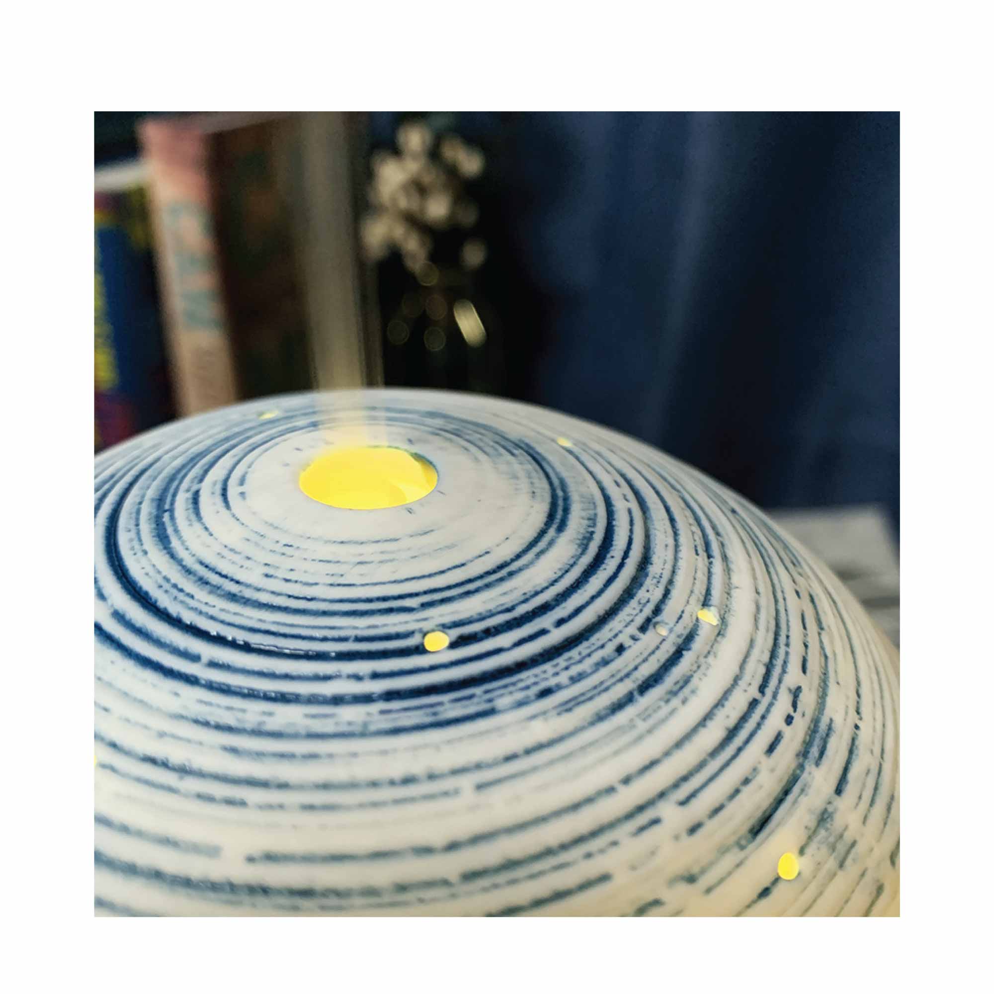 Essential Oil Aroma Diffuser in blue and white ceramic ball shape with black base, showcasing mist and LED lights.