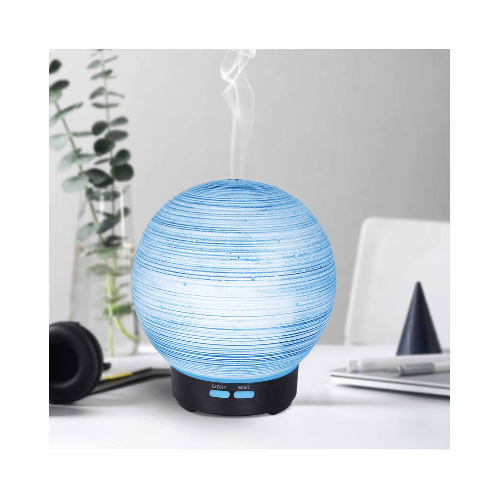 Essential Oil Aroma Diffuser in blue and white ceramic ball shape with black base, showcasing mist and LED lights.