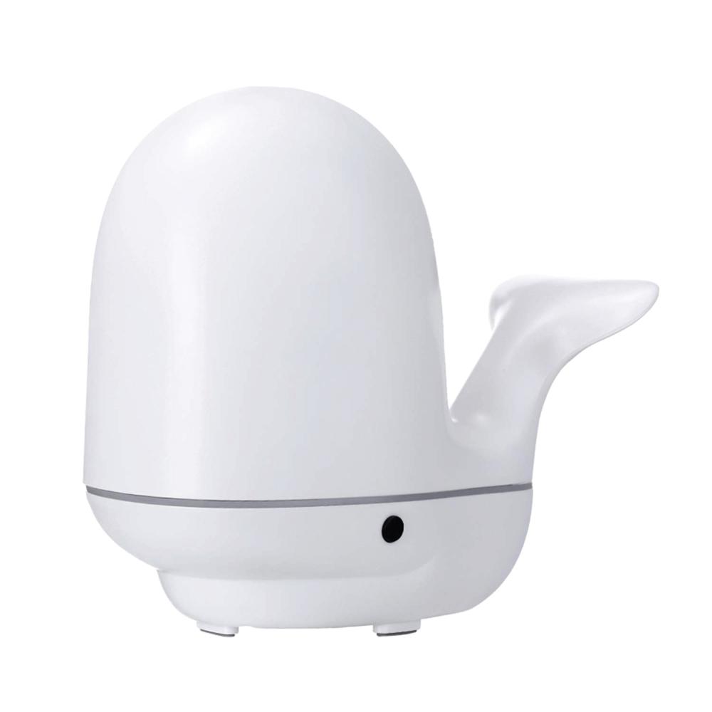 A colorful whale-shaped ultrasonic aroma diffuser with LED lights, designed for children's rooms, showcasing its mist output.