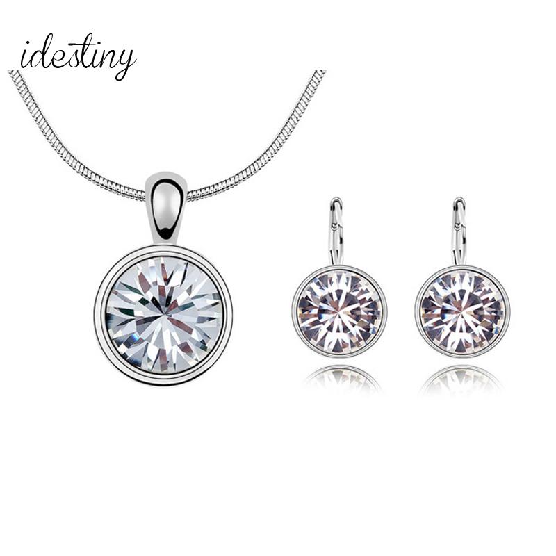 Elegant bridal jewelry set featuring a necklace and earrings made with Swarovski Elements crystals, showcasing a diamond-like shine.