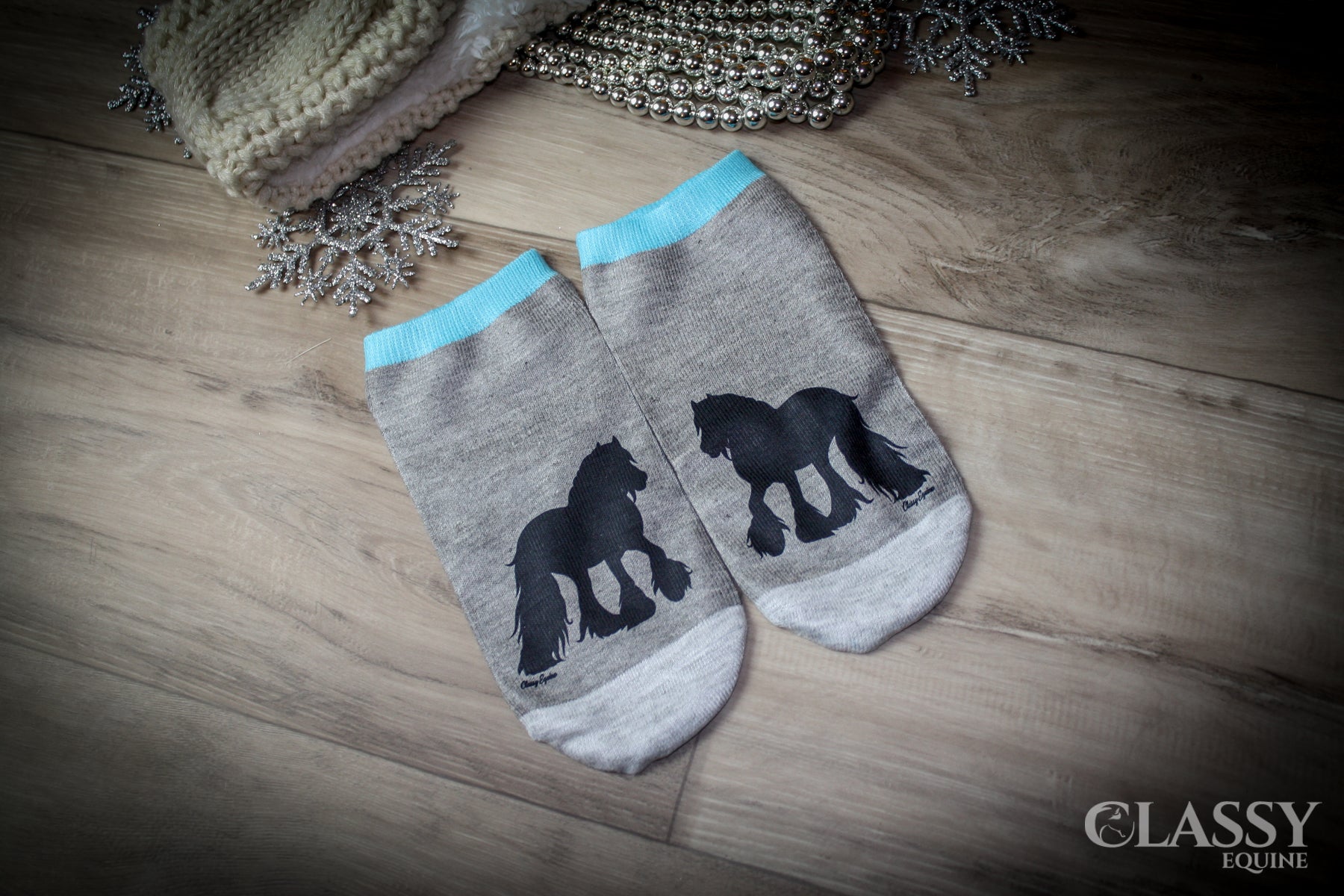 A collection of colorful no-show women's fashion socks in blue, pink, purple, light gray, and dark gray, displayed neatly.