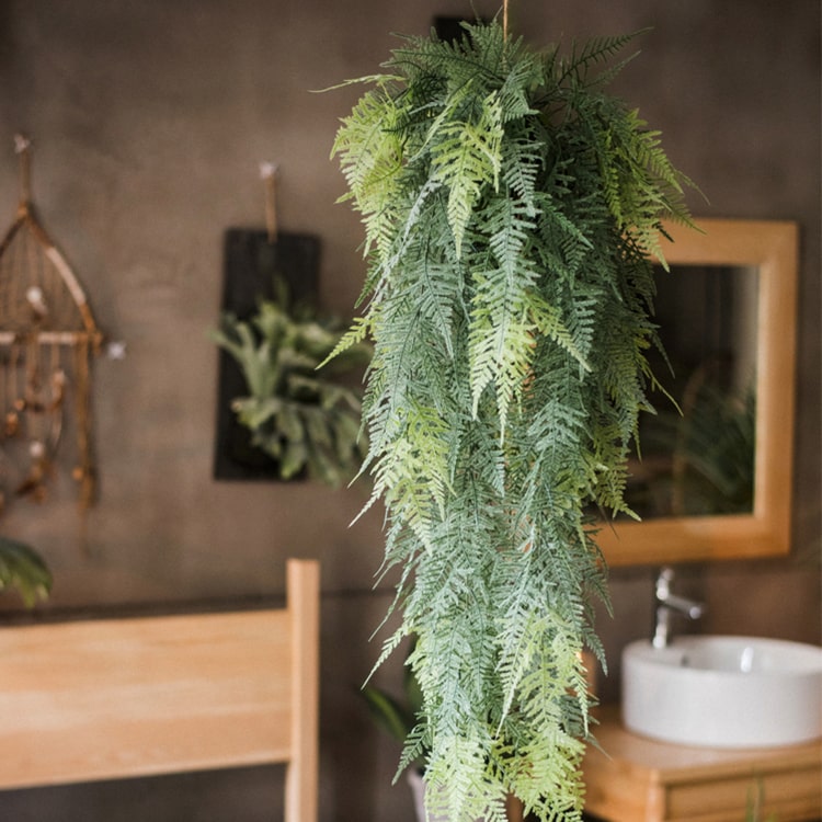 A lush Faux Artificial Asparagus Setaceus Hanging Fern Plant, showcasing vibrant green leaves and a realistic design, perfect for home decor.