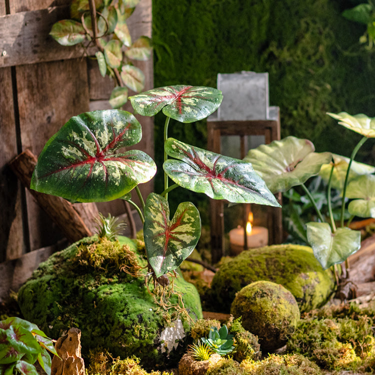 A 19-inch tall faux artificial Alocasia plant with realistic green leaves, perfect for home or office decor.