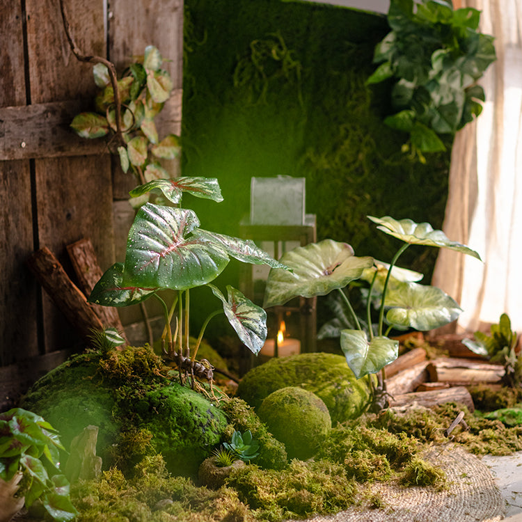 A 19-inch tall faux artificial Alocasia plant with realistic green leaves, perfect for home or office decor.