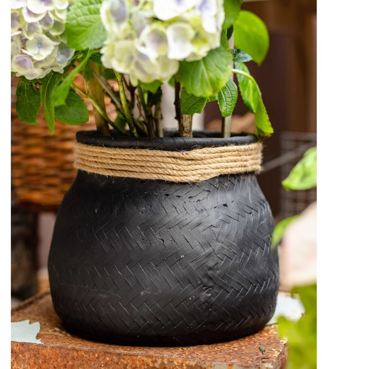 Faux Bamboo Woven Cement Planter in black and white with khaki hemp rope accents, showcasing its stylish design and drainage hole.