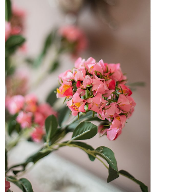 A 27-inch tall Faux Silk Artificial Senna Plant Flower Stem in pink, white, and yellow colors, showcasing realistic silk petals and lush greenery.