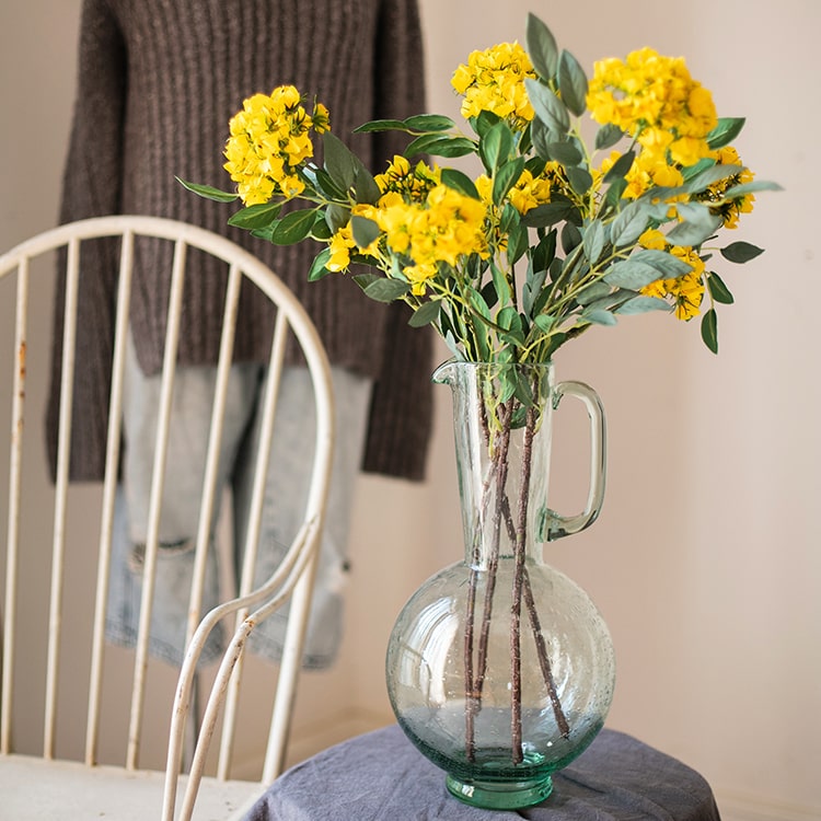A 27-inch tall Faux Silk Artificial Senna Plant Flower Stem in pink, white, and yellow colors, showcasing realistic silk petals and lush greenery.