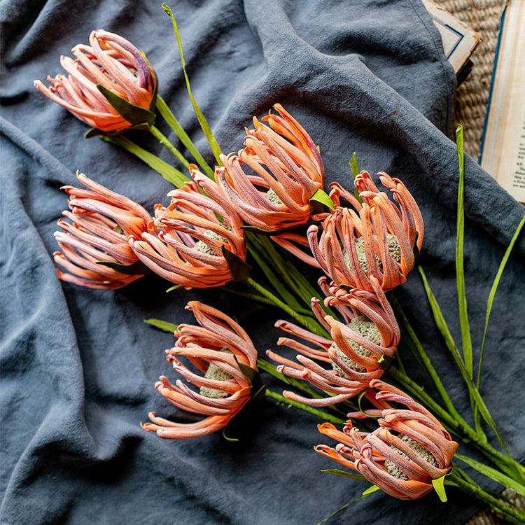 A 39-inch tall faux silk sunflower stem with vibrant orange red and white blooms, showcasing realistic petals and a green stem.