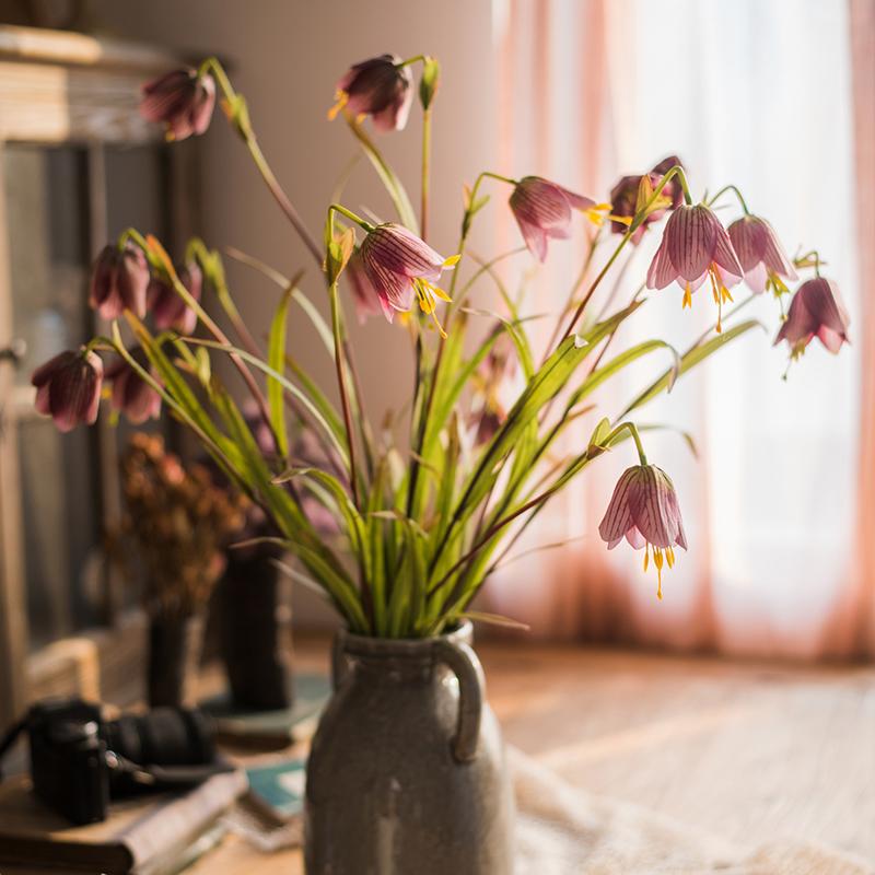 A vibrant faux silk fritillaries lily flower stem in pink and purple, showcasing three blooms and lush green leaves, standing 26 inches tall.