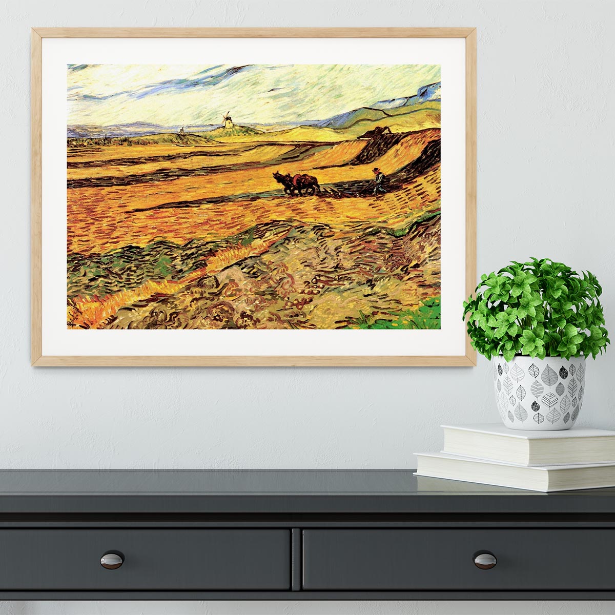 Framed print of Van Gogh's 'Field with Ploughman and Mill', showcasing vibrant colors and intricate details.