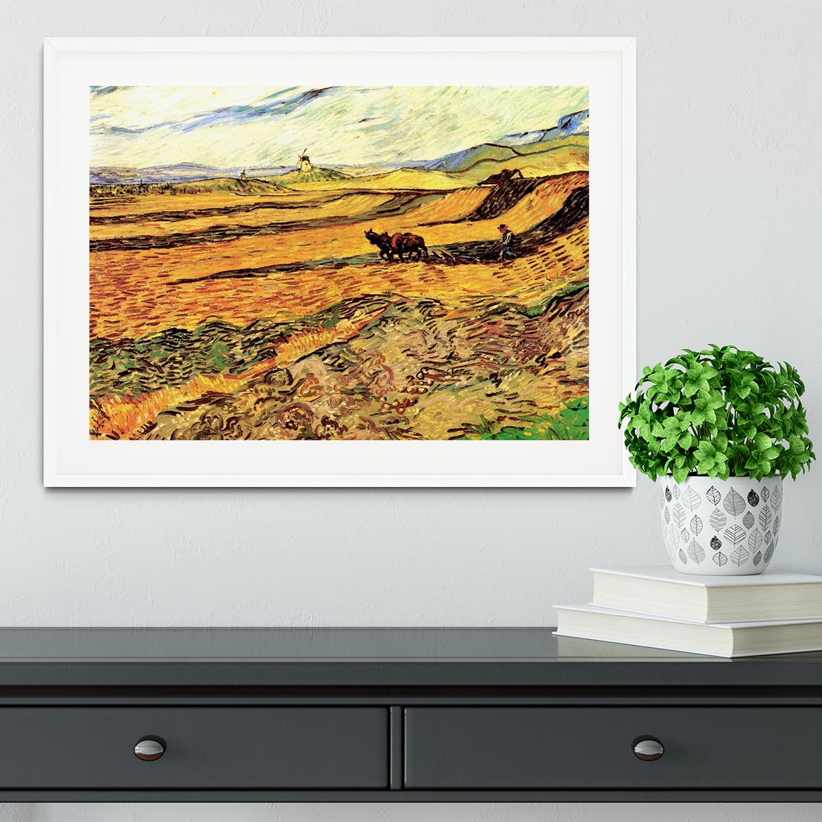 Framed print of Van Gogh's 'Field with Ploughman and Mill', showcasing vibrant colors and intricate details.