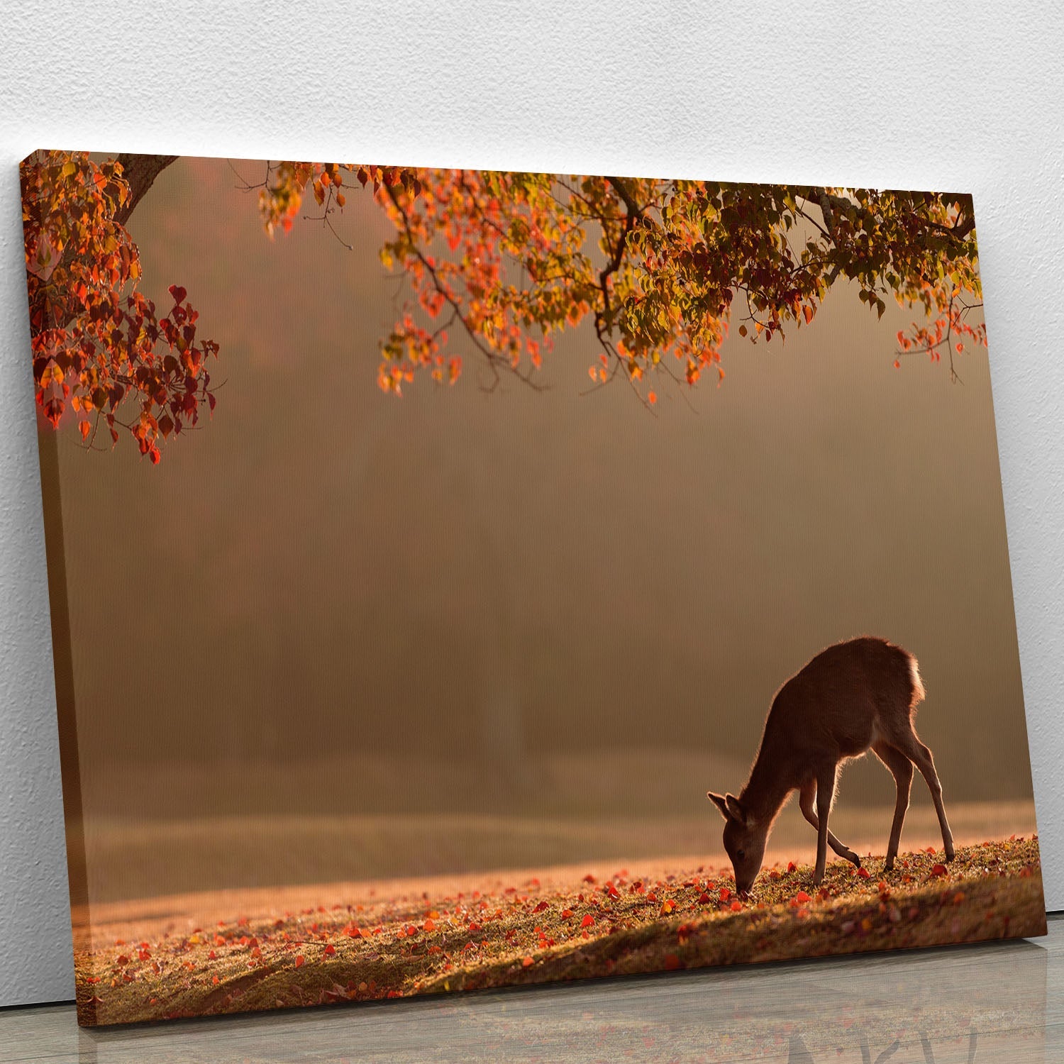A beautiful canvas print featuring vibrant autumn leaves in warm colors, perfect for home decor.
