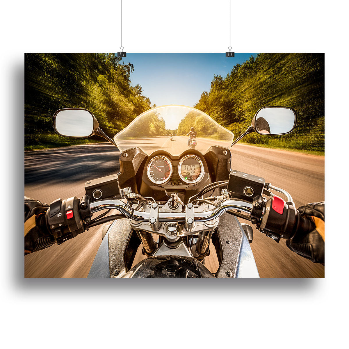 A vibrant canvas print featuring a first-person view of a motorbike ride, showcasing a scenic landscape and the thrill of adventure.