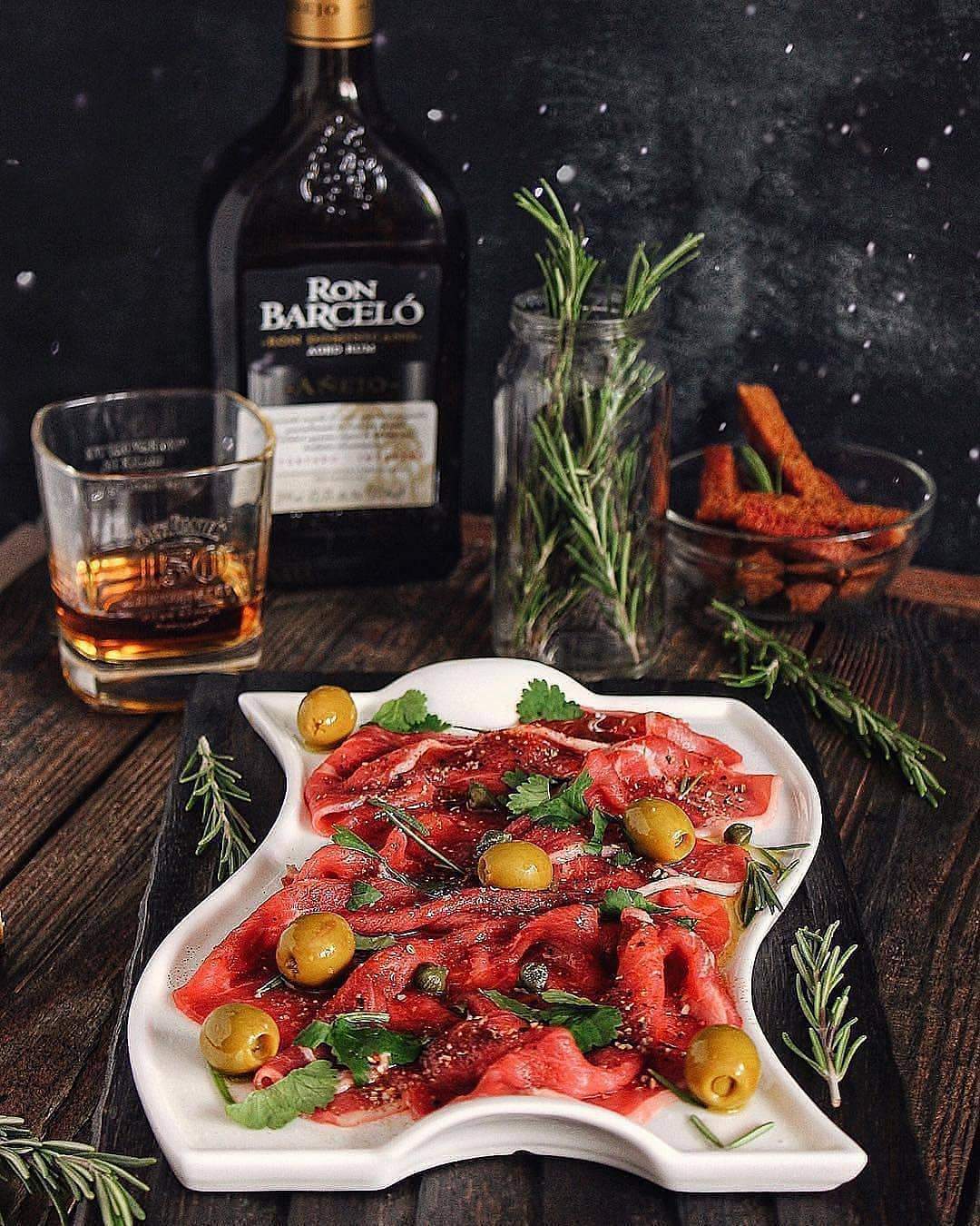 Flat white porcelain serving dish with handles, 10 inches long, featuring a wavy rolled rim, perfect for elegant dining.