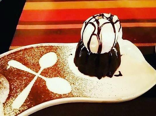 Flat white porcelain serving dish with handles, 10 inches long, featuring a wavy rolled rim, perfect for elegant dining.