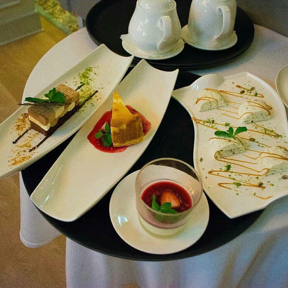 Flat white porcelain serving dish with handles, 10 inches long, featuring a wavy rolled rim, perfect for elegant dining.