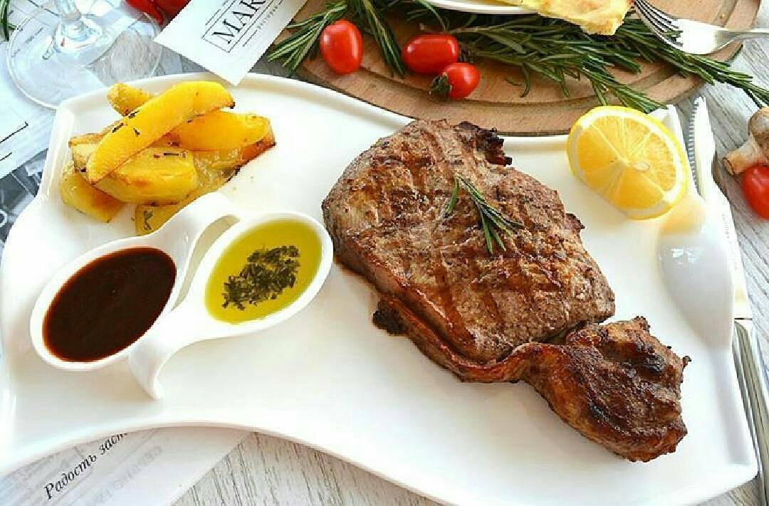 Flat white porcelain serving dish with handles, 10 inches long, featuring a wavy rolled rim, perfect for elegant dining.