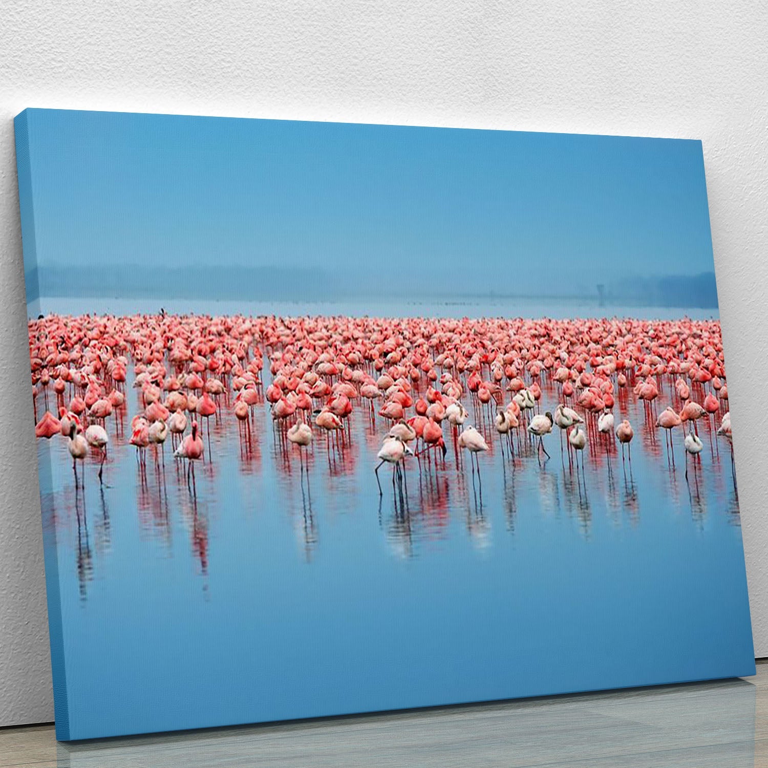 A vibrant canvas print featuring a flock of flamingos in a serene setting, showcasing their elegant poses and beautiful colors.